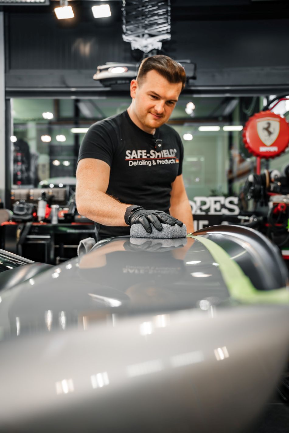 Tim applying a coating to grey vehicle paintwork with a microfibre applicator